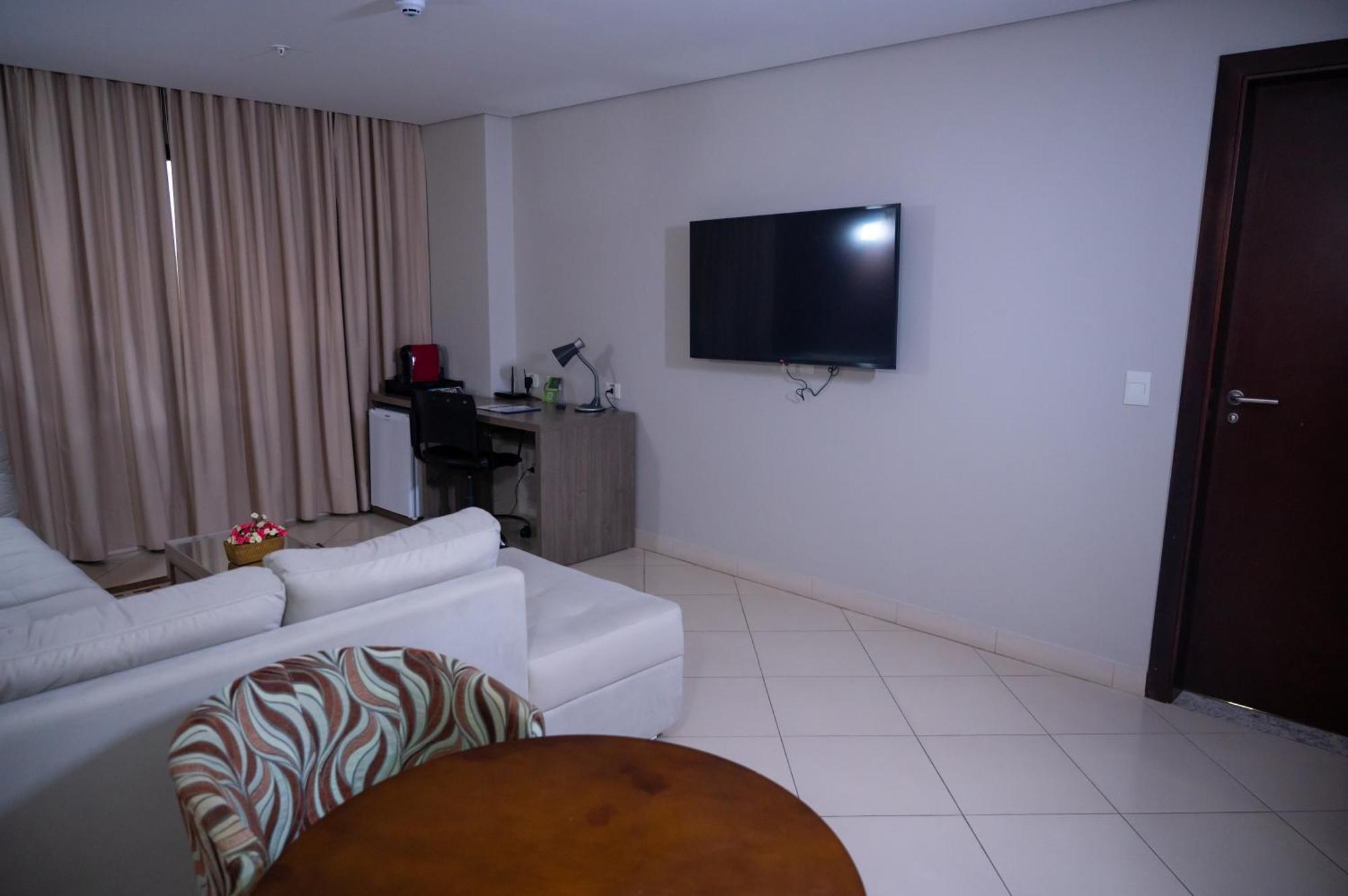 Hotel Inter Cuiaba Exterior photo A living room with a television set